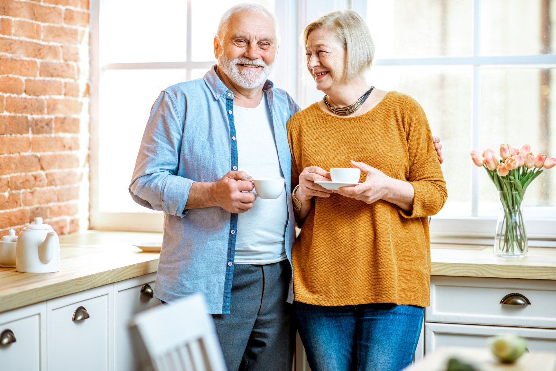 Older couple talking together in their kitchen