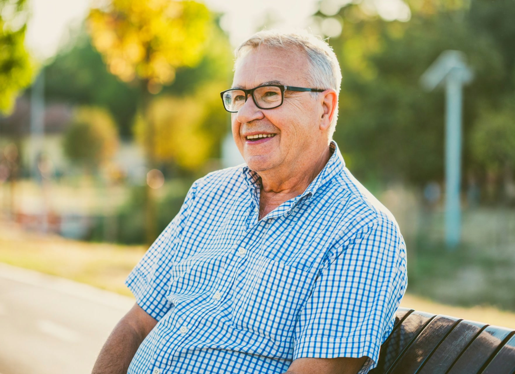 Older man sitting on a bench outdoors