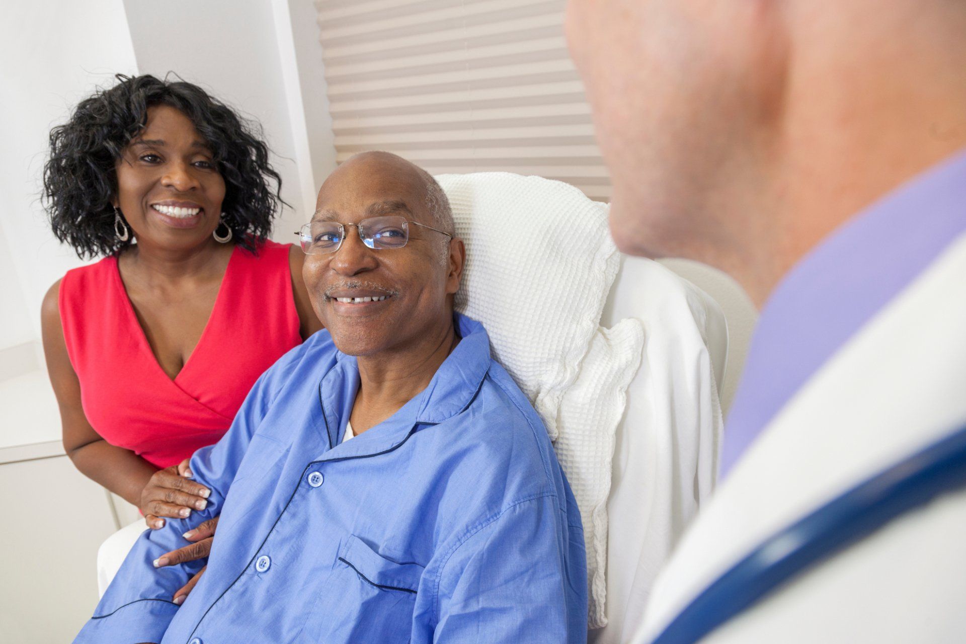 Doctor talking to a patient and family member in a hospital