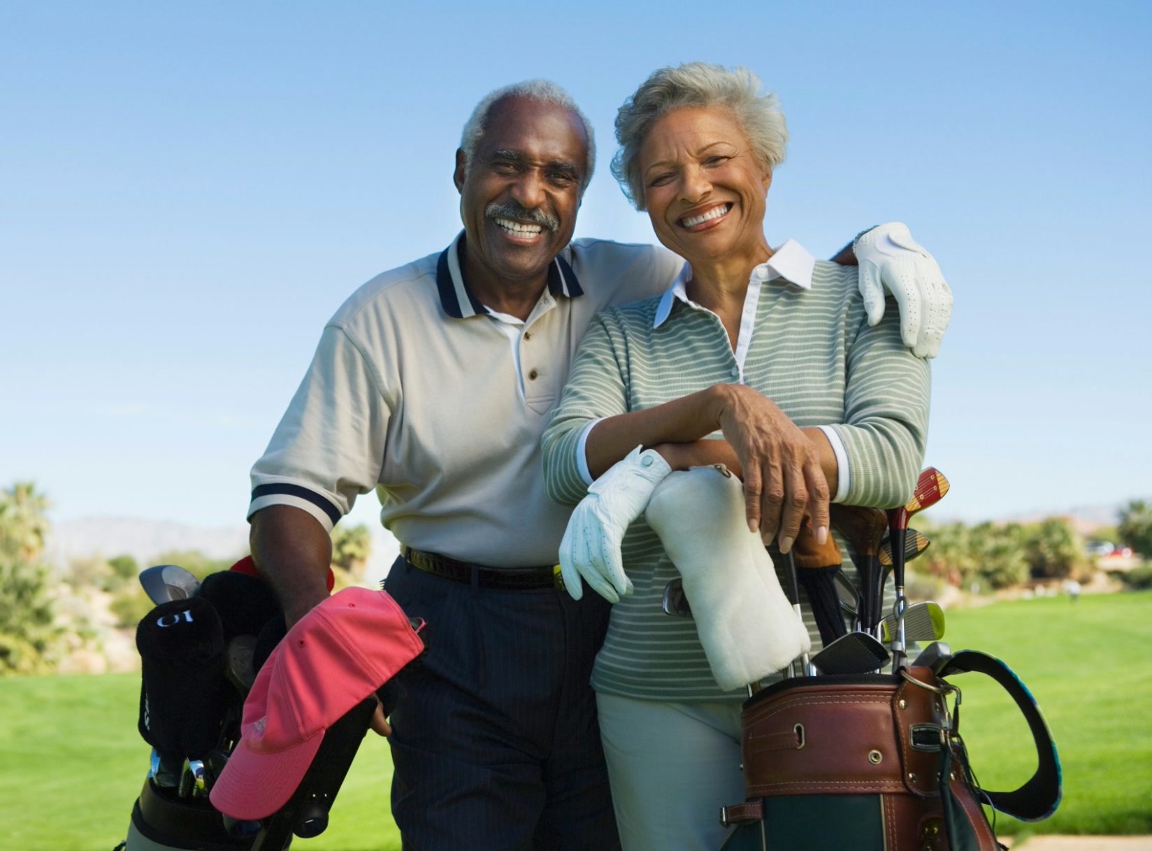 Older couple playing golf